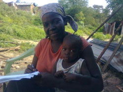 Monica with the youngest of her four children. She says the family rarely gets diarrhea since their WASH education